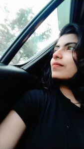 A soon-to-be mother gazes out of a car window with hope and wonder, reflecting on her pregnancy journey and the beautiful life growing within her